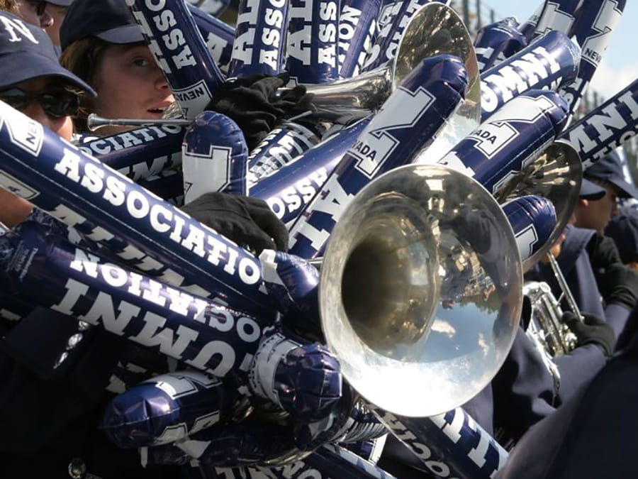 A trumpet surrounded by University of Nevada, Reno-themed noisemakers at homecoming