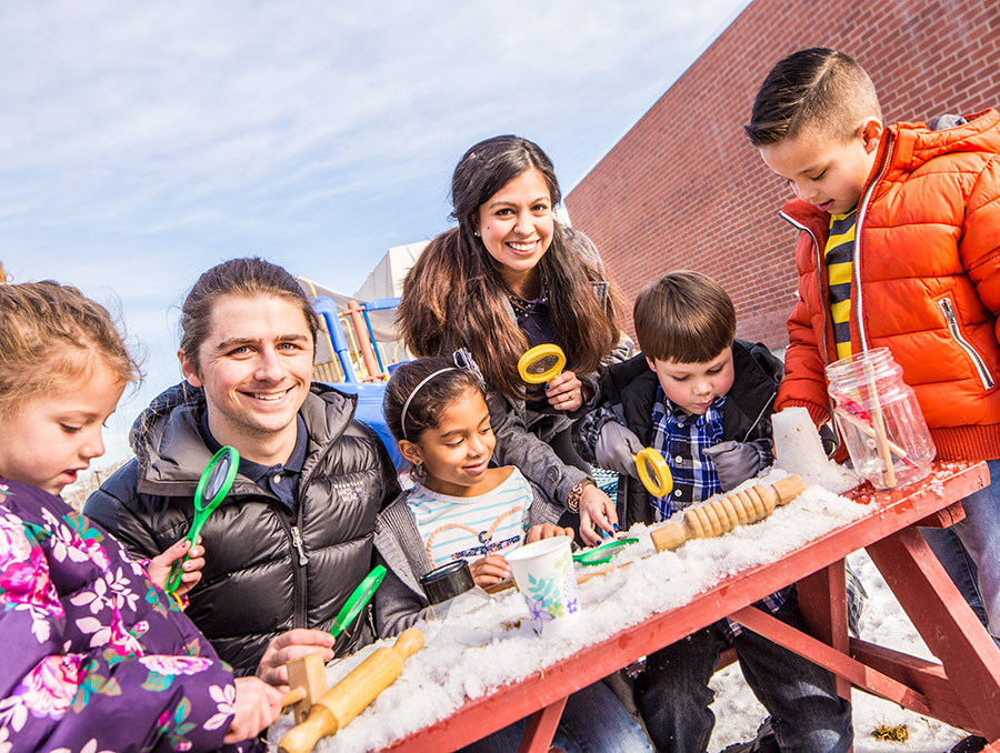 Kids with teachers at a table in the winter