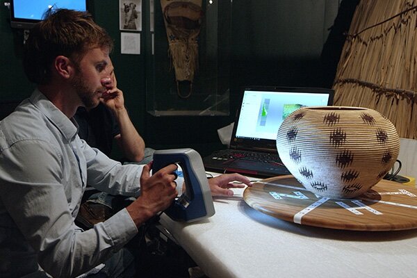 Man uses 3D scanner to capture historically significant Native American basket for viewing in VR as part of a larger VR-based basket museum.