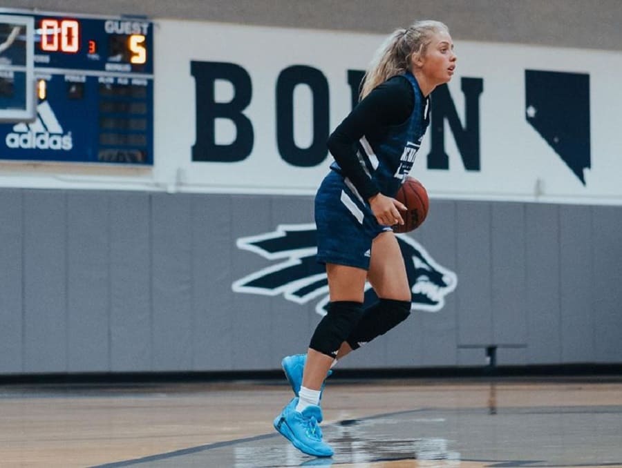 Kylie Jimenez with a basketball on the court at practice