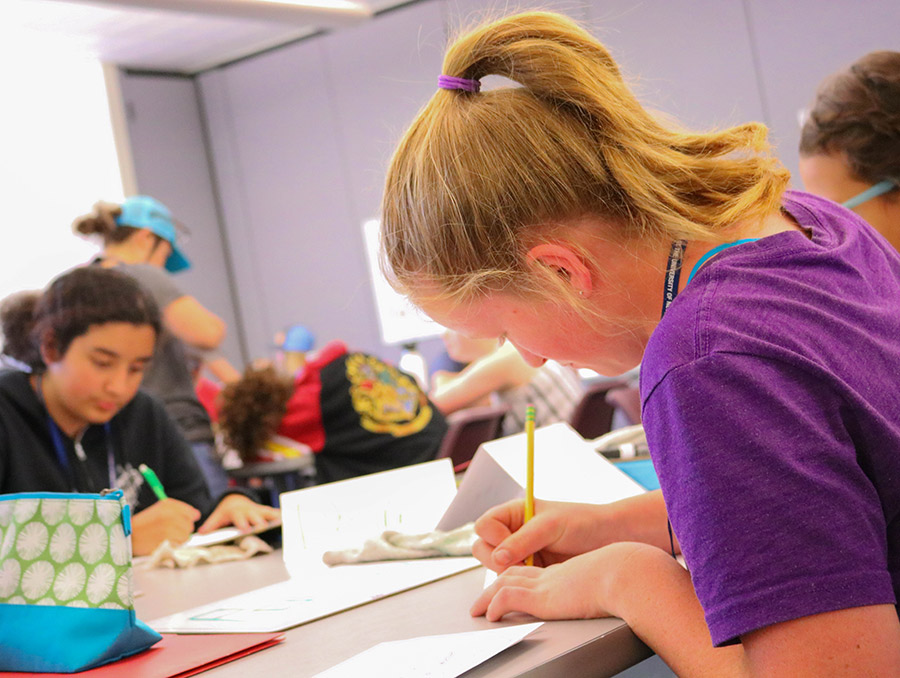 Student working on a math assignment in a classroom