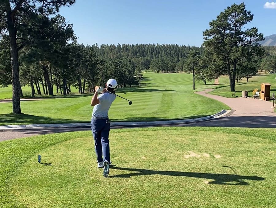 Quim Vidal Mora teeing off on a beautiful green golf course