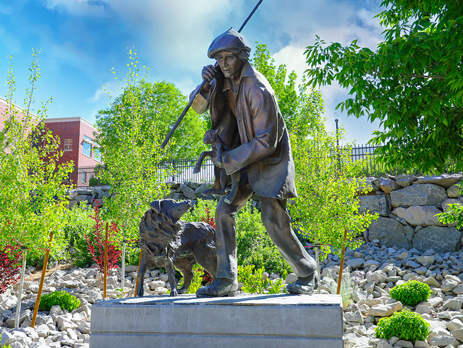 Statue of Basque Sheepherder holding lamb with dog by his side