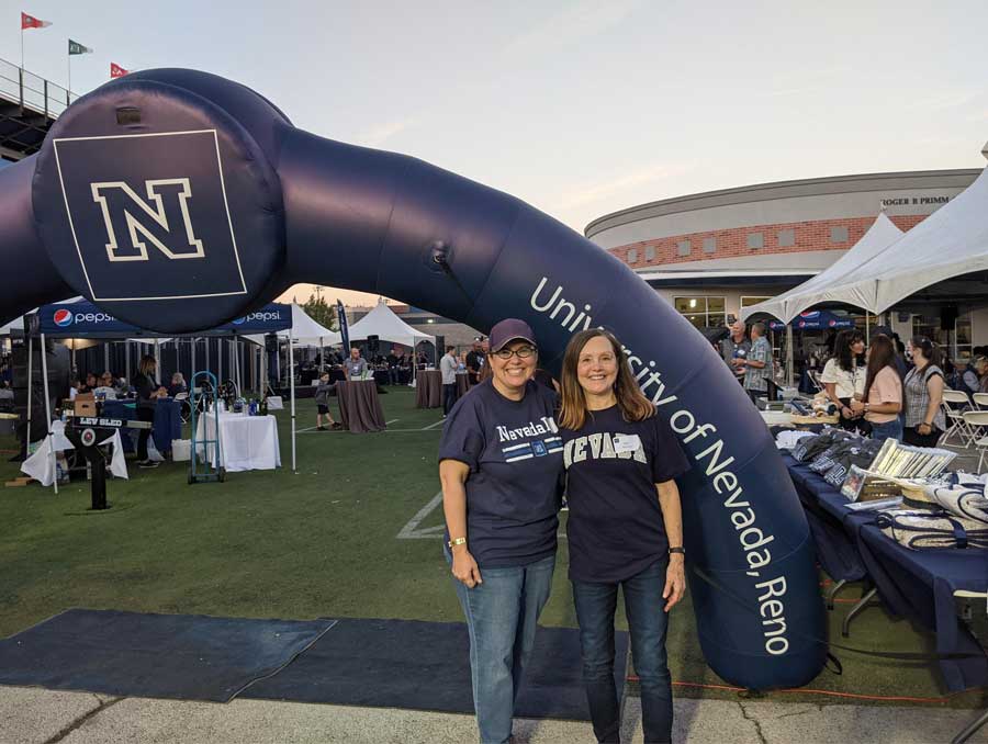 Debera Thomas and Muge Akpinar at a University football game