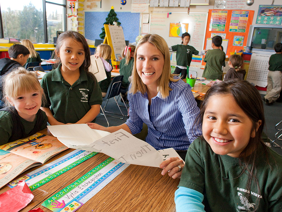 Teacher reading to smiling students