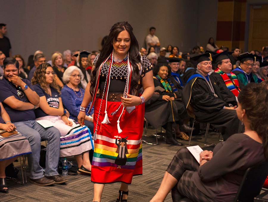 Students and professors celebrate in graduation ceremony.