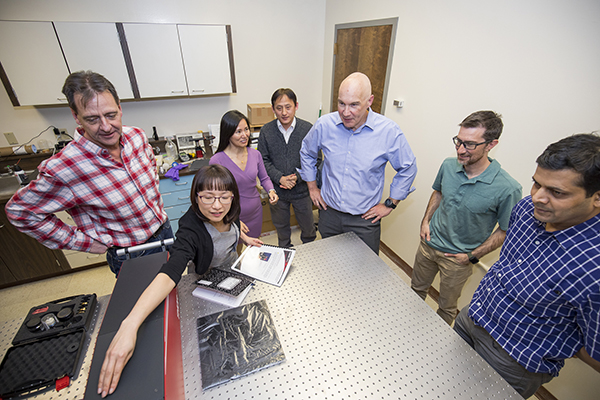 Dr. Earley at a table with his team. 