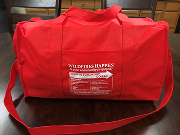 A red bag labeled for wildfire evacuations. 