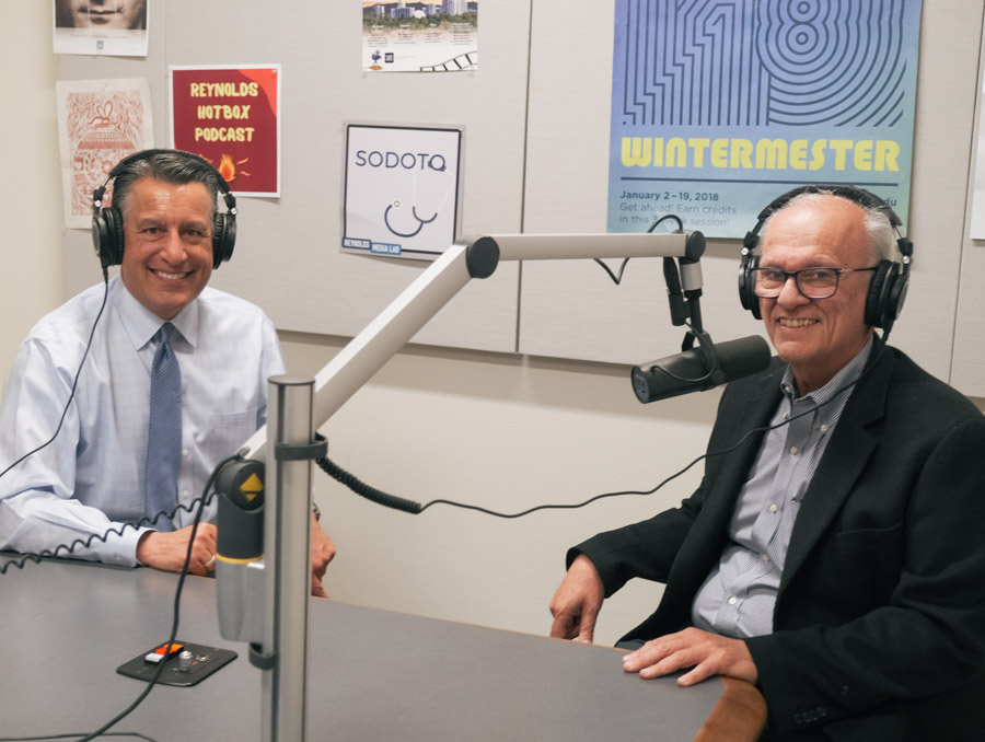President Brian Sandoval and Dean Manos Maragakis in the recording studio with headphones on