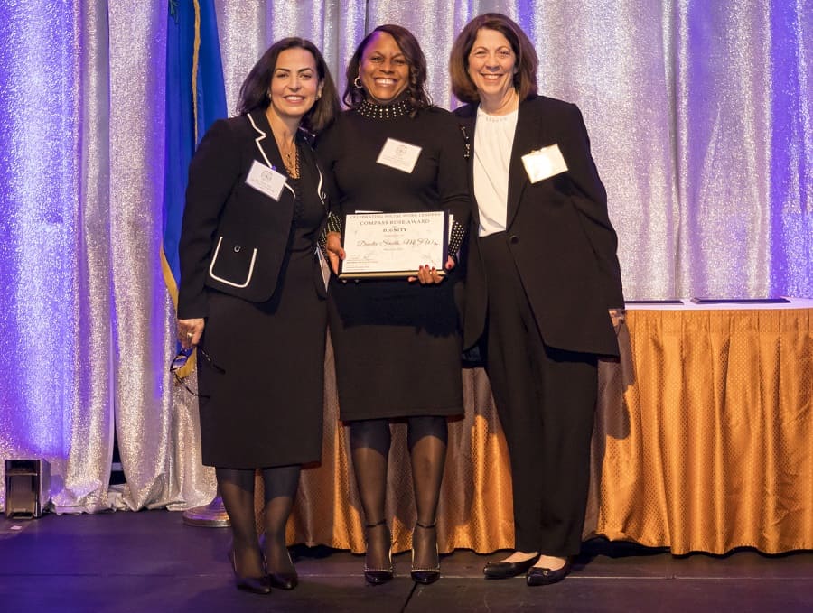 Founding Dean Shadi Martin and Associate Dean Lillie Wichinsky presenting Dinita Smith with Compass Rose Dignity Award