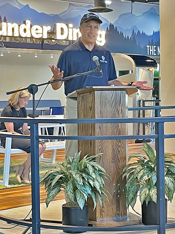 President Sandoval speaks from a podium in the Downunder Dining Commons