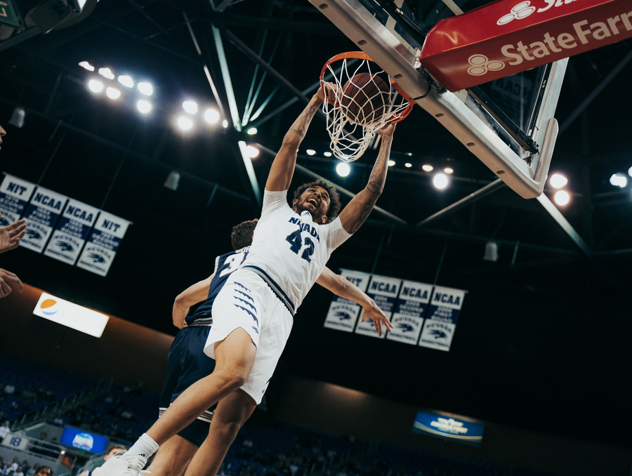 K.J. Hymes dunking a basket in Lawlor Event Center