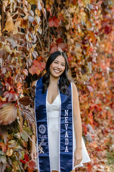 Sarah Danen poses outside in graduation regalia.