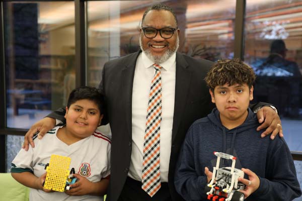 Dean Easton-Brooks with Wolf Pack Bot students who are holding their robots