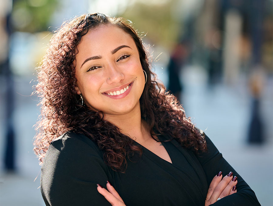 Deja Sonju headshot outdoors.