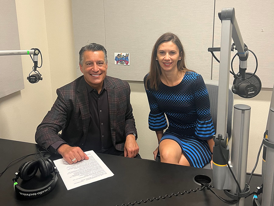 President Sandoval sits to the left of Dr. Mariann Vaczi in a podcast recording room.