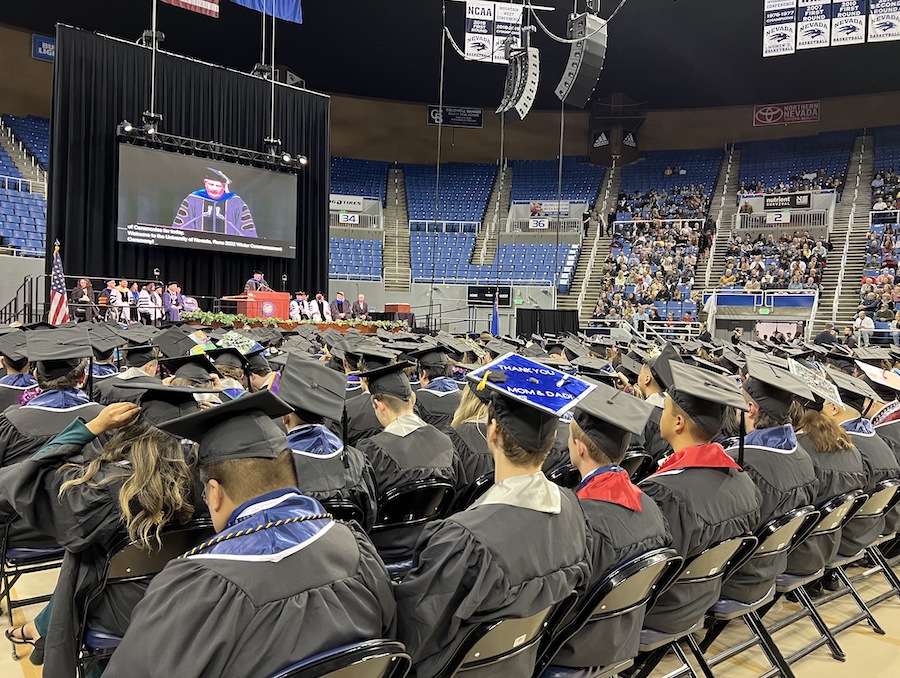 Graduates from the winter 2022 commencement ceremony look at the main stage at Lawlor as the ceremony begins.