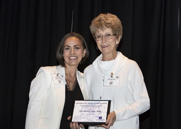 Chancellor Emeritus Jane Nichols poses with Dean Shadi Martin after winning the Outstanding Social Work Collaboration Award