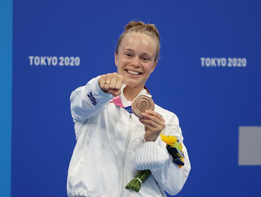 Krysta Palmer holding her bronze medal