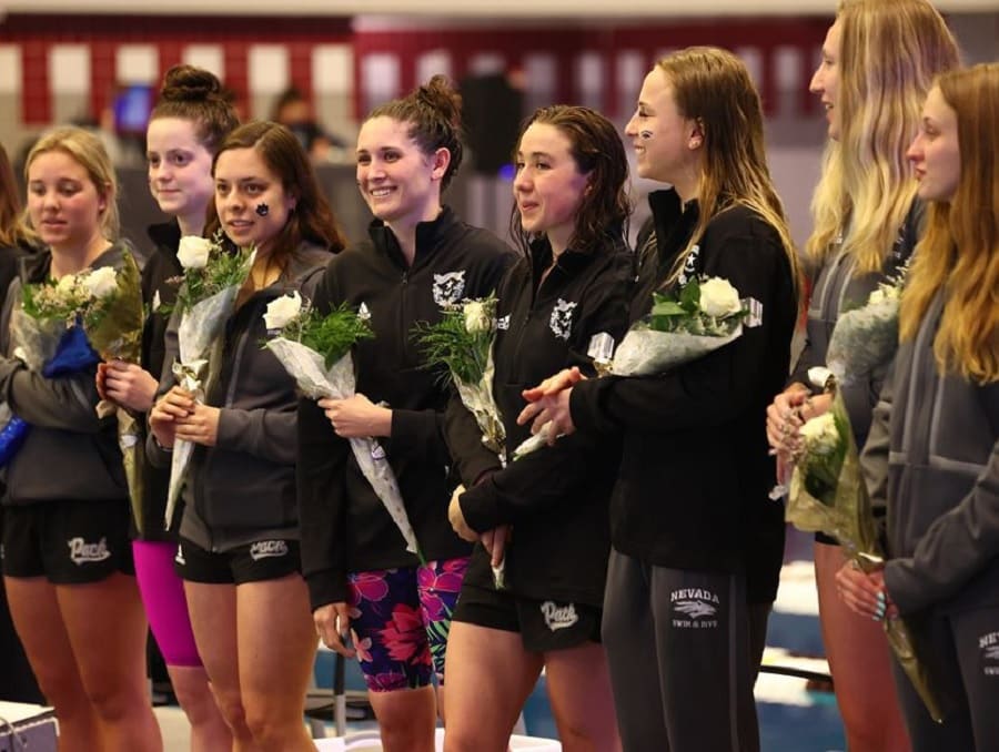 The Nevada Swim and Dive team holding flowers at the awards ceremony