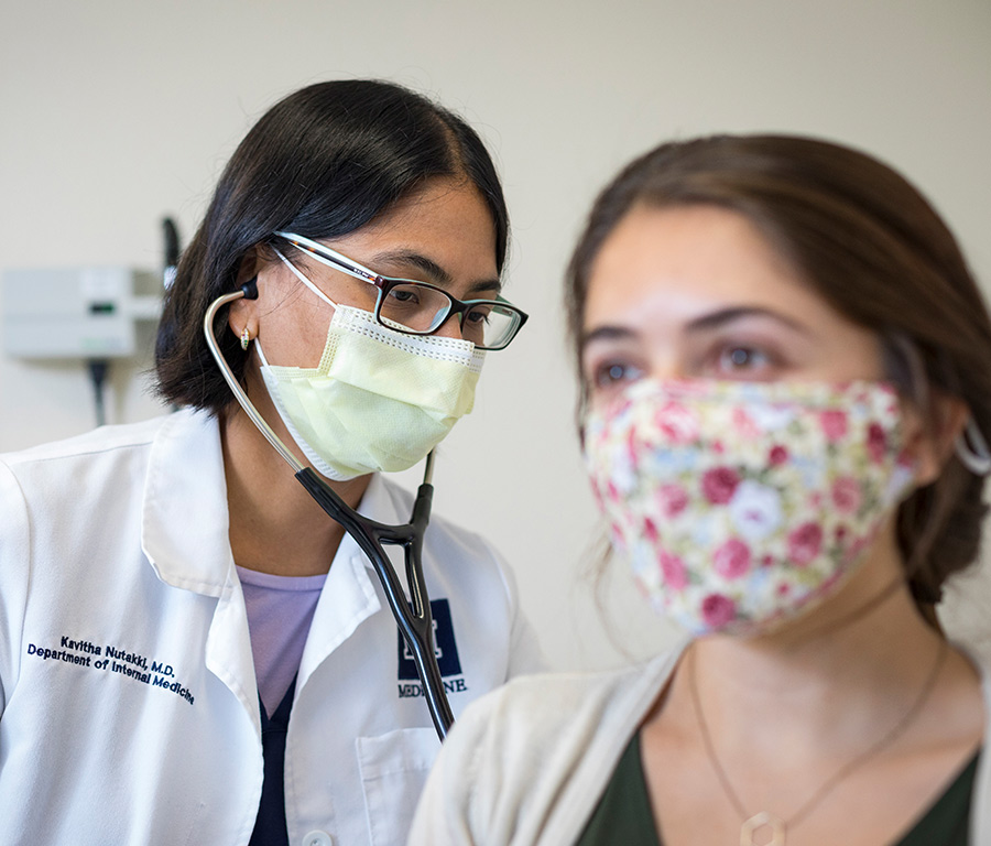 Doctor examining a patient wearing masks