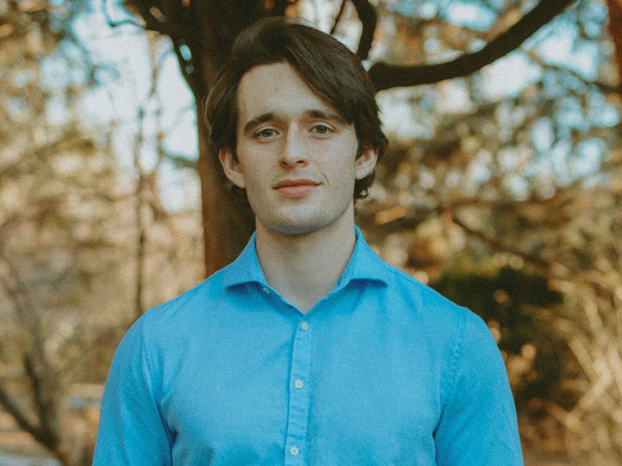 Joseph Hill standing in front of tree.