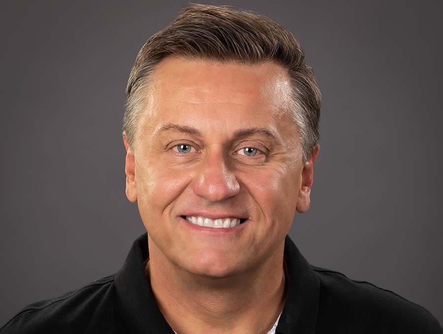 A close-up headshot of Dr. Todd Felts in front of a grey background