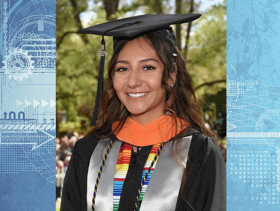 Woman standing outside wearing graduation cap and gown