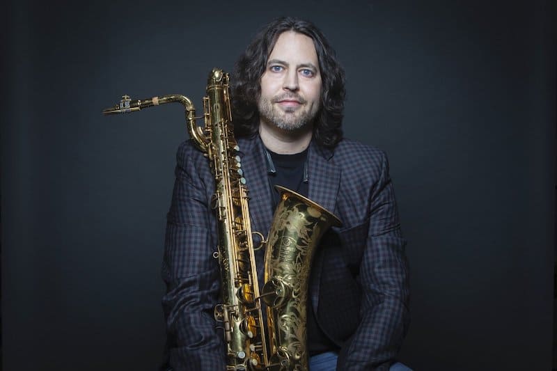 Brian Landrus holding his saxophone for a photo.
