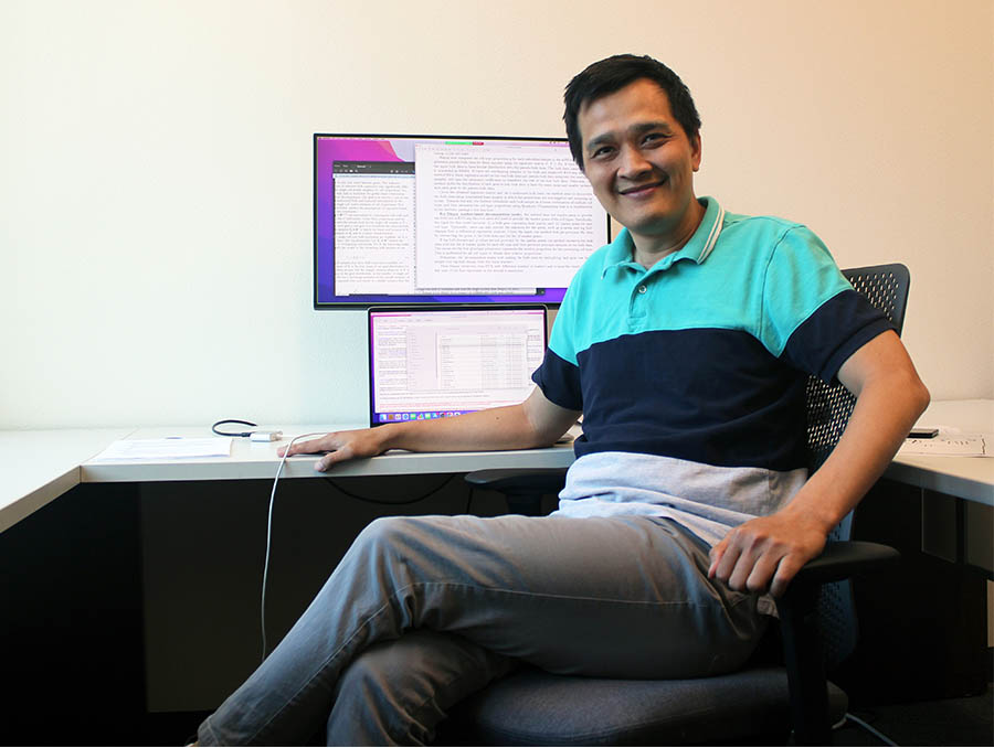 Man sitting in chair in front of computer screen