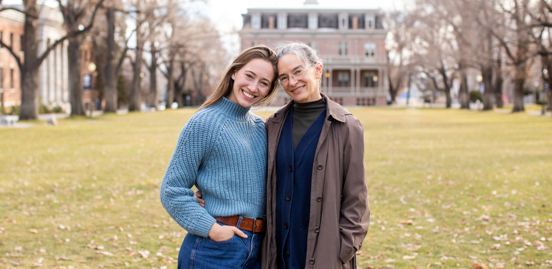 Katherine and her daughter Eliza smile on the University quad.