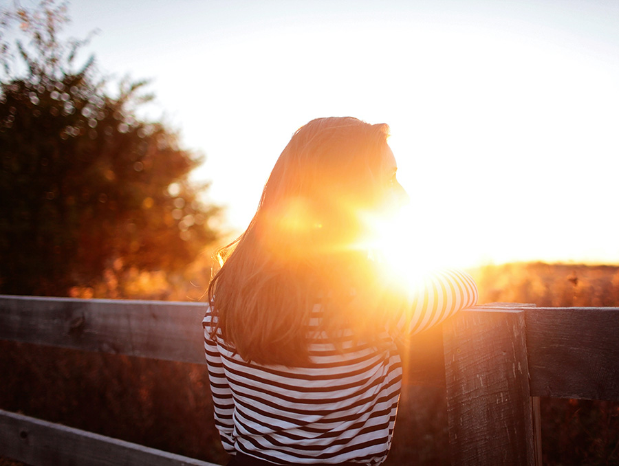 Woman with sunbeams in her face. 