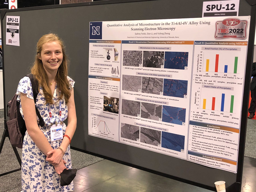 Sydney Fields in front of her poster presentation.