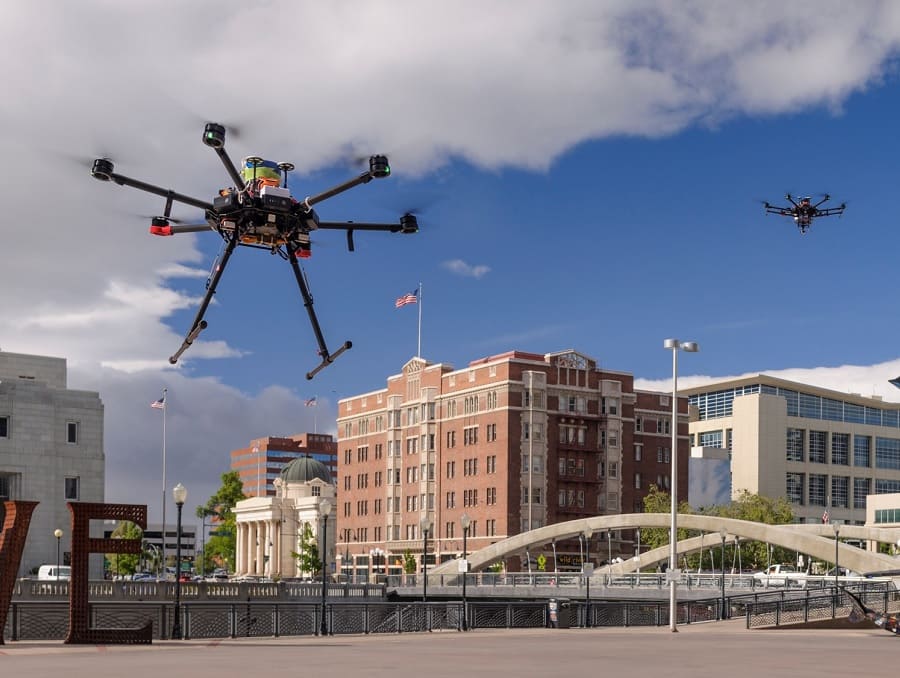 Drones in the sky with University in background.