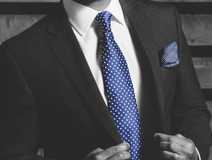 Man wearing suit with blue tie and blue pocket square