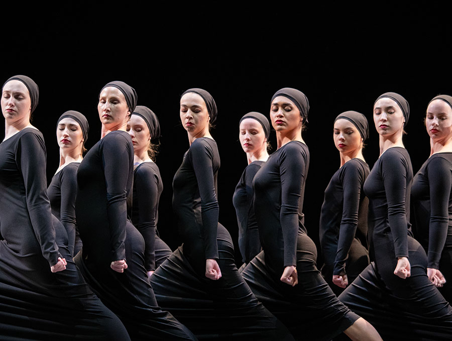 Student dancers perform on dark stage