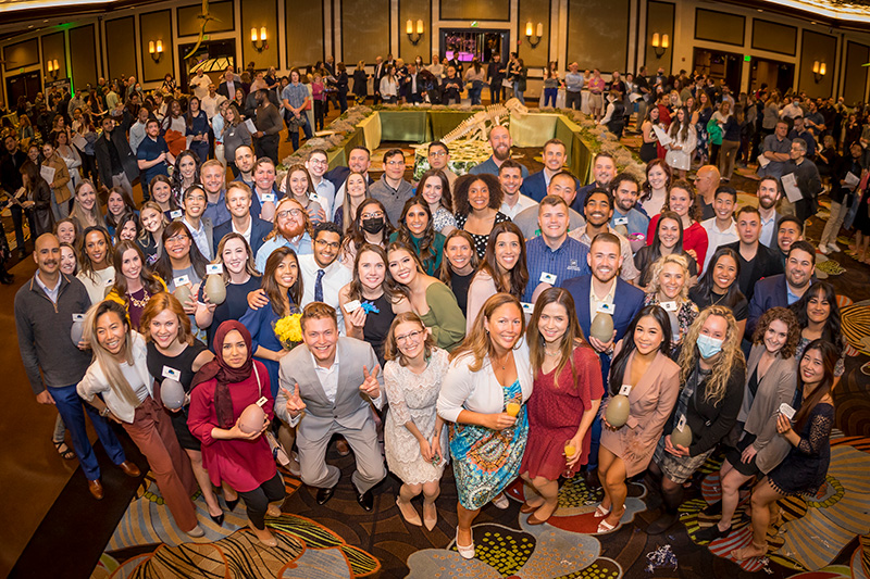 Fourth-year med students pose in a casino ballroom