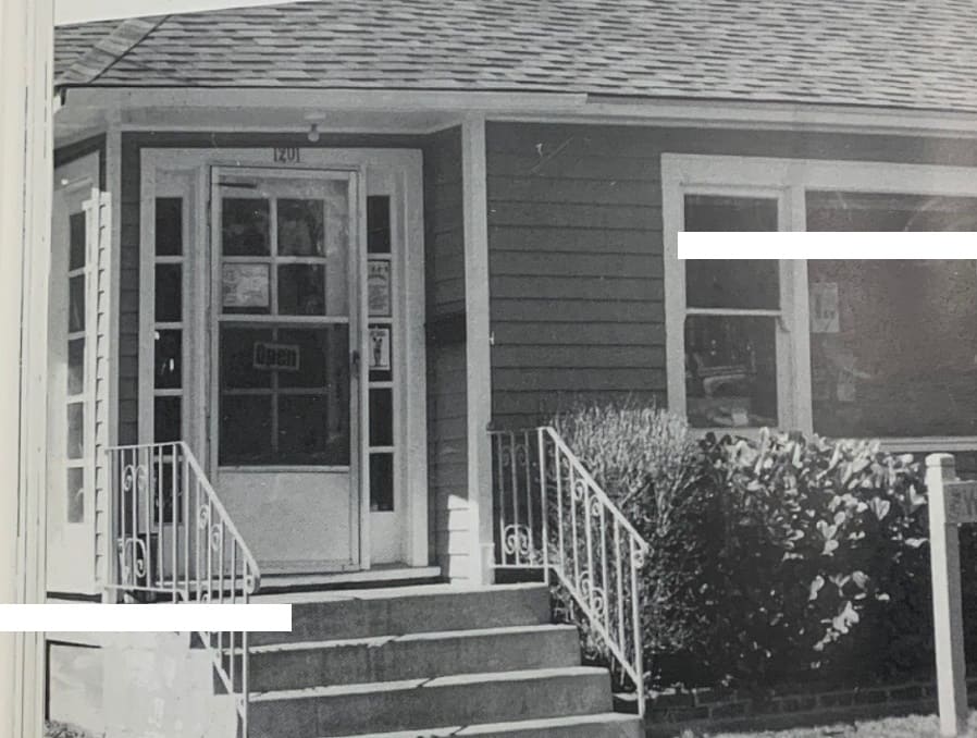 A black and white photo of the former Women's Resource Center with artistic white lines on the right and left of the image