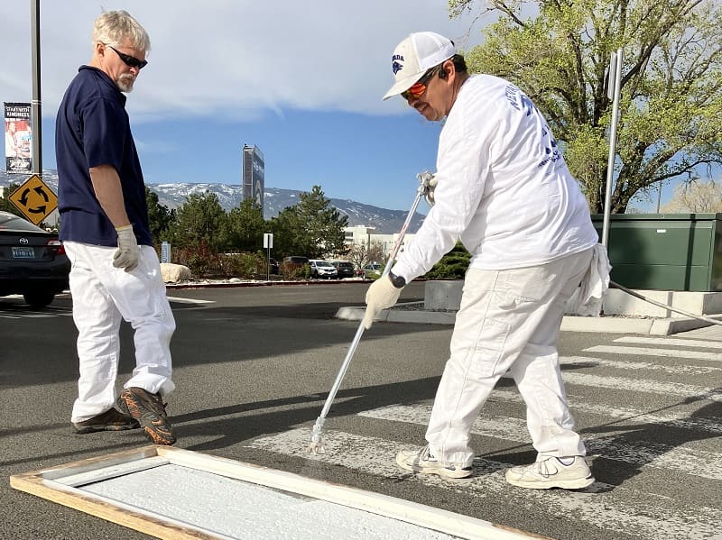 Darren Schryer and Oscar Martinez painting a crosswalk