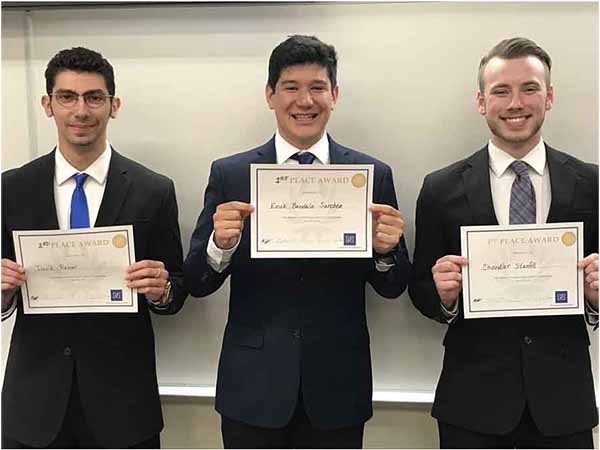 Three winners of the 2022 Madani-Gordaninejad Speech Competition stand in a row, holding awards. 