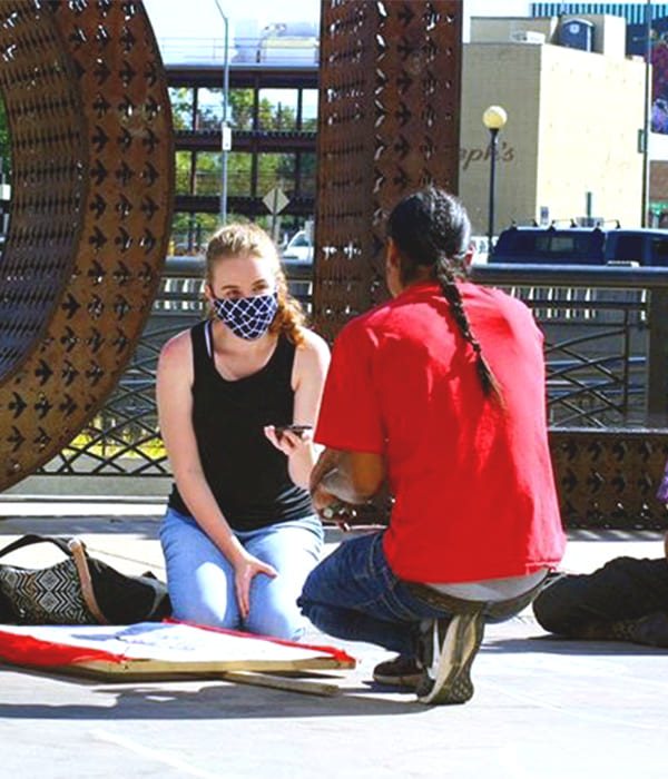 Faith Evans interviewing someone at the Believe Plaza.