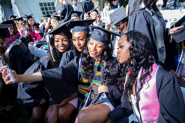 A group of graduates posing for a selfie photo