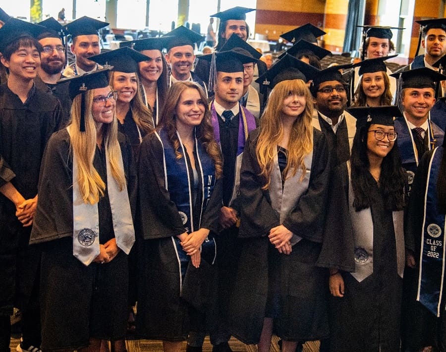 The Spring 2022 Honors Graduates pose for a photo as a group, smiling at the camera
