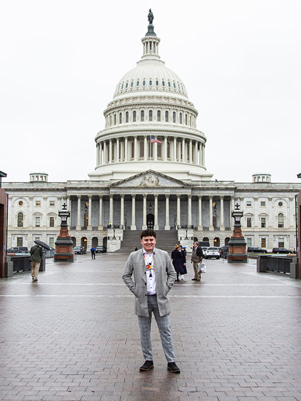 Jarrette Werk standing in front of the Washington DC Capitol building.