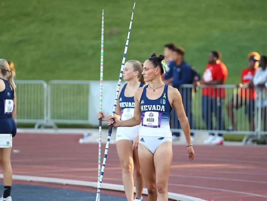 Women's Track and Field athletes on the track holding javelins