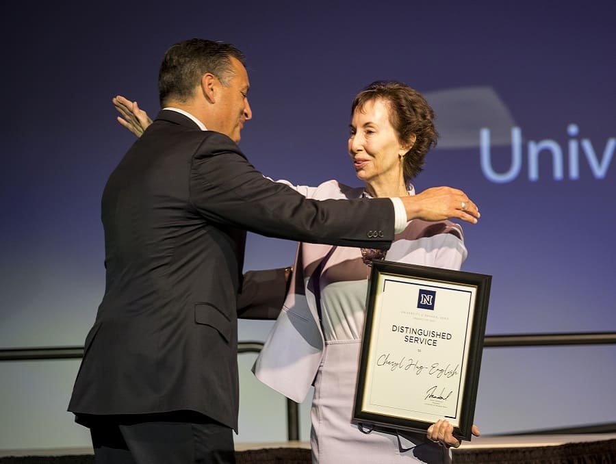 President Sandoval going to hug Dr. Hug-English after presenting her with her award