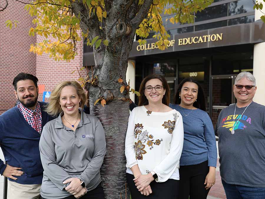 Joe Garton, Caroline Hatcher, Alisha Shaw, Vivian Bolanos and Jill Smith in front of the College of Education and Human Development Building