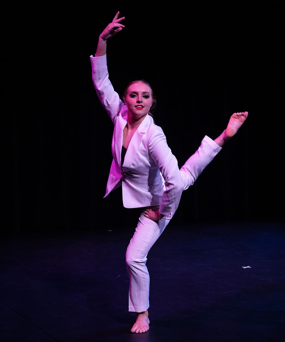 A Fall Festival dancer striking a pose on stage.