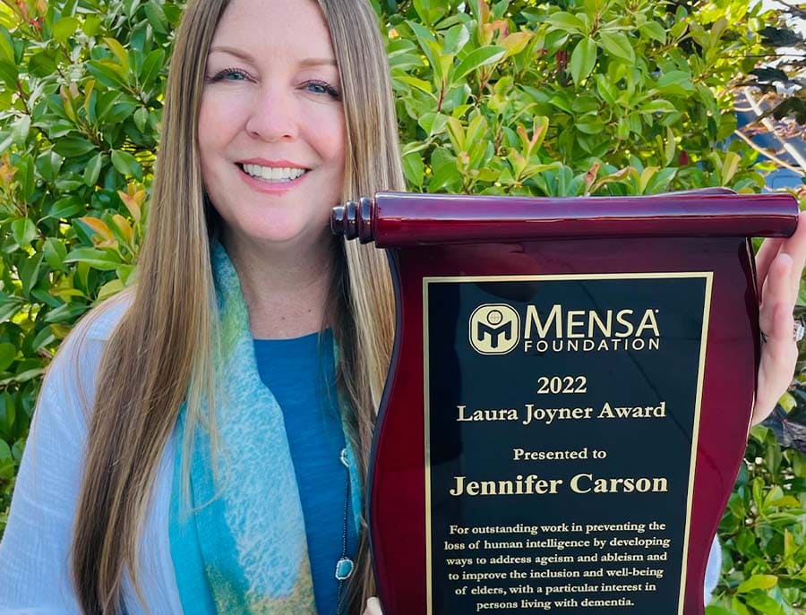 Jennifer Carson holding the Laura Joyner Award, presented by the Mensa Foundation. 