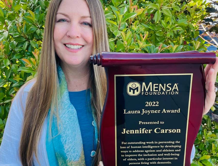 Jennifer Carson holding the Laura Joyner Award, presented by the Mensa Foundation. 
